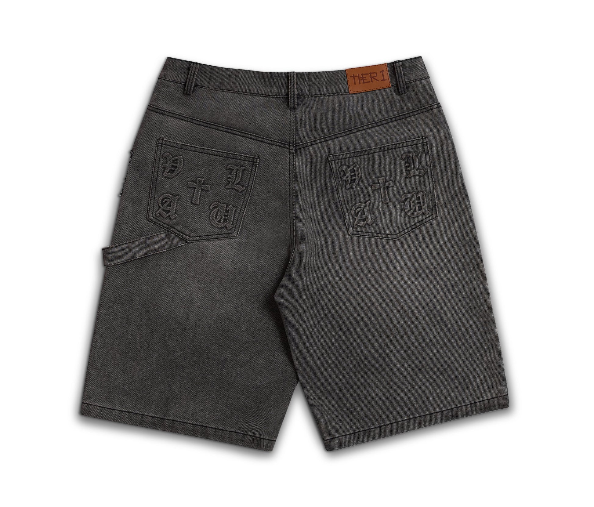 A pair of dark gray washed denim shorts shown from the back, featuring decorative embossed patch pockets with 'PATRIOT' lettering and a brown leather brand tab at the waistband.