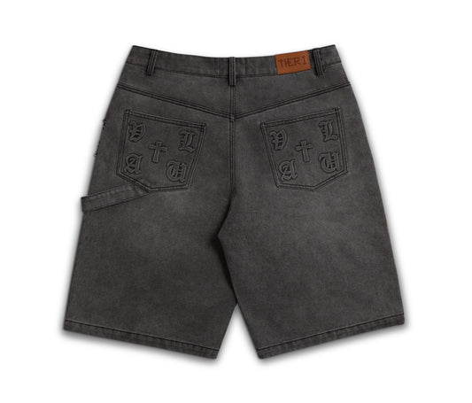 A pair of dark gray washed denim shorts shown from the back, featuring decorative embossed patch pockets with 'PATRIOT' lettering and a brown leather brand tab at the waistband.